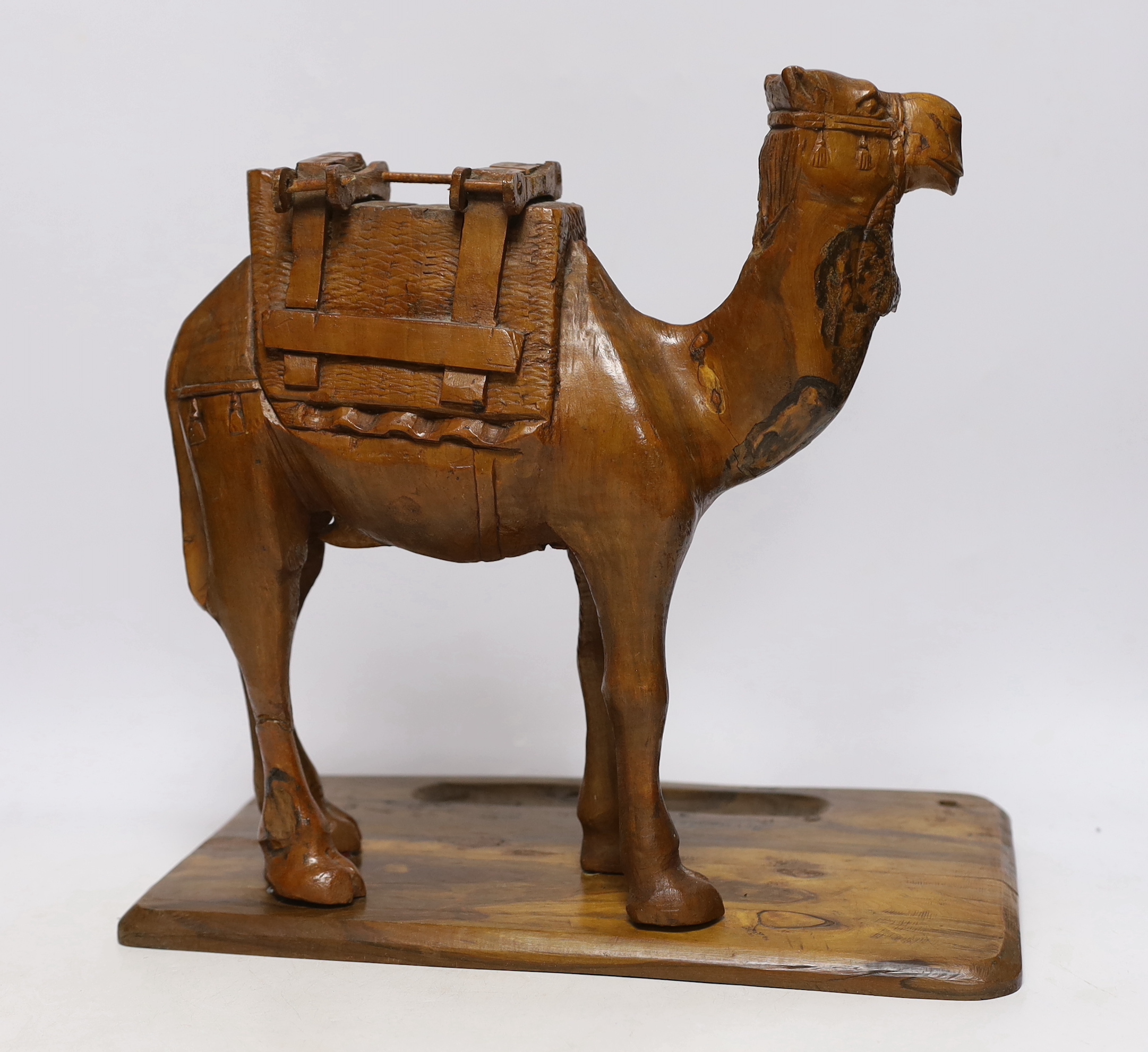 A Jerusalem carved olivewood camel pen / desk ink stand, 34cm wide